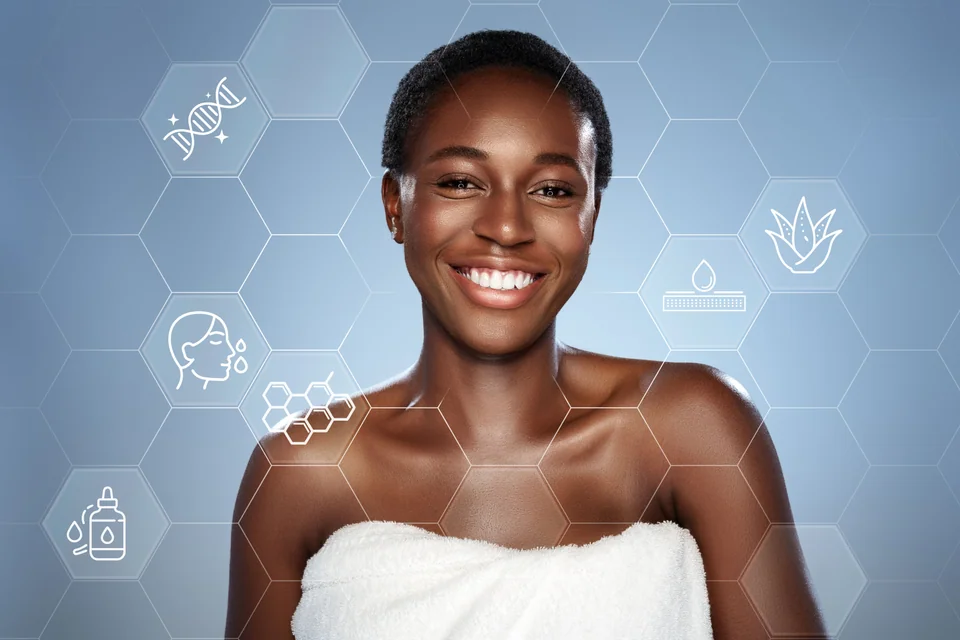 Smiling woman covered in towel shows skincare benefits in modern spa setting during daytime