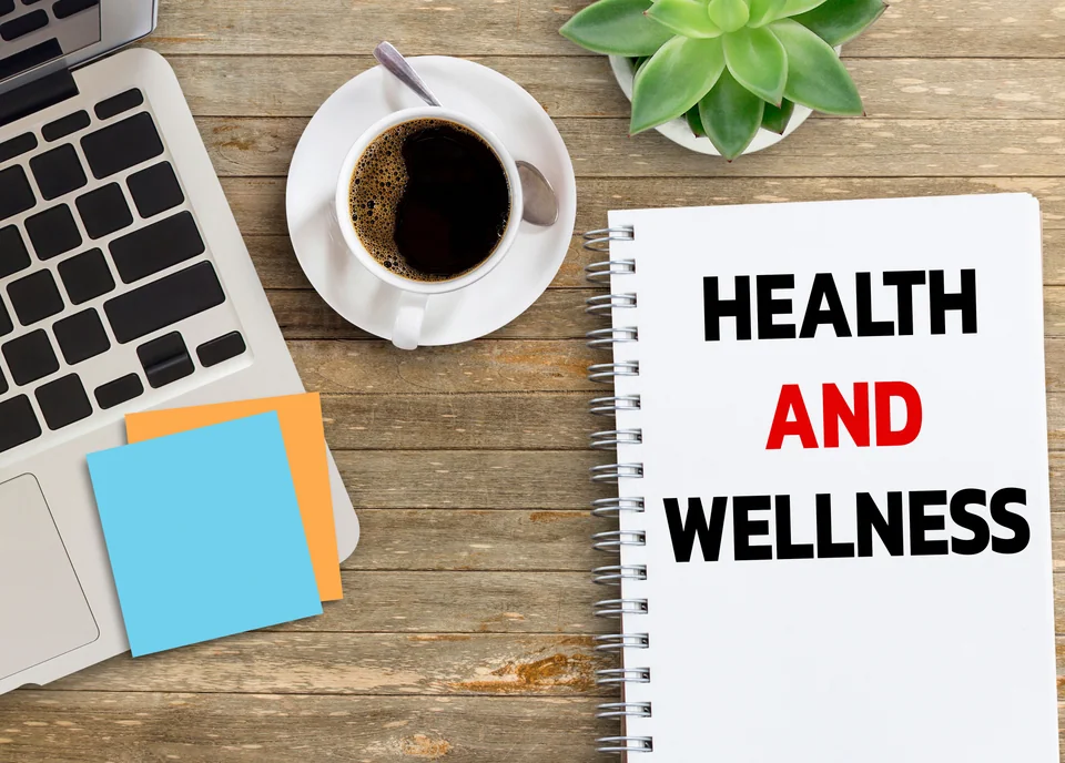 Business quotes, HEALTH AND WELLNESS on notebook or paper in office desk